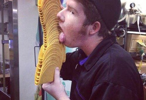 Employee at Taco Bell licks tacos